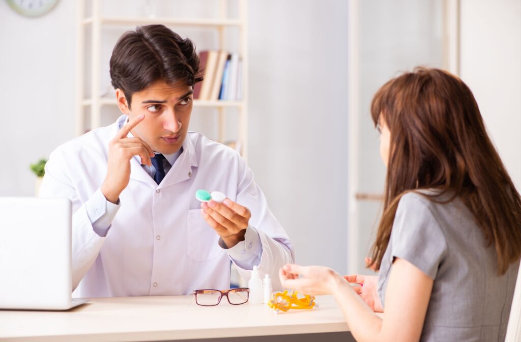  An optometrist explains proper contact lens wear and care to their patient during their annual fitting.