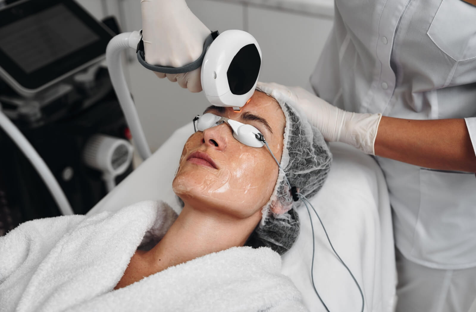 An adult with protective jelly on their face gets a photofacial.